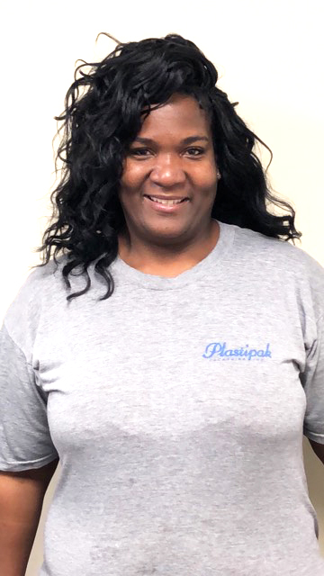 Lady with shoulder length hair smiling and posing for a photo