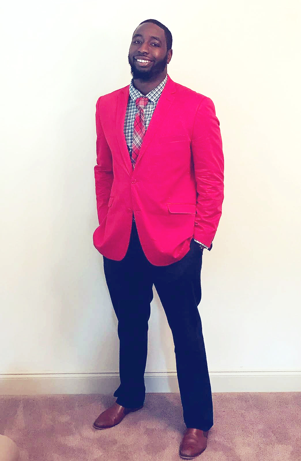 Young man in red suit coat and black pants smiling and posing for a photo. Hans Rice II, DPT, Encore Rehabilitation-Eufaula, Alabama
