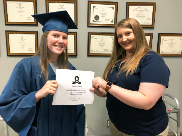 Athlete of the Month Hannah Popwell receiving her "Honorary Degree as Rehab Specialist" from Encore Rehabilitation-Dothan's Summer Reynolds, LPTA