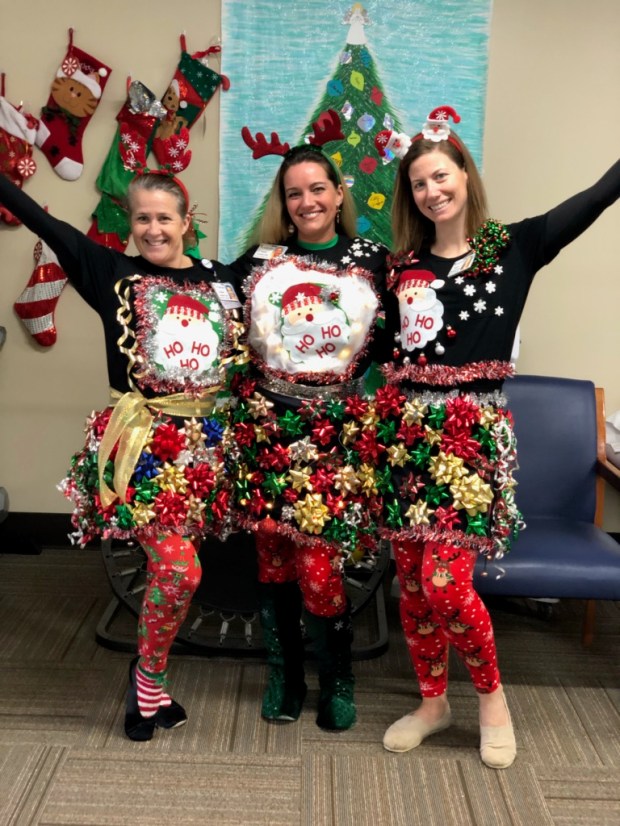 Encore Rehabilitation Therapists Susan, Jamie, and Hope prepare to compete in the "ugly sweater" contest at Andalusia Physical Therapy #EncoreRehab