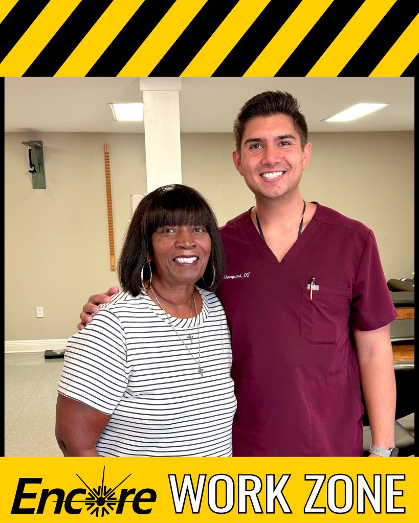 Smiling lady who is a workers' comp patient standing with smiling occupational therapist