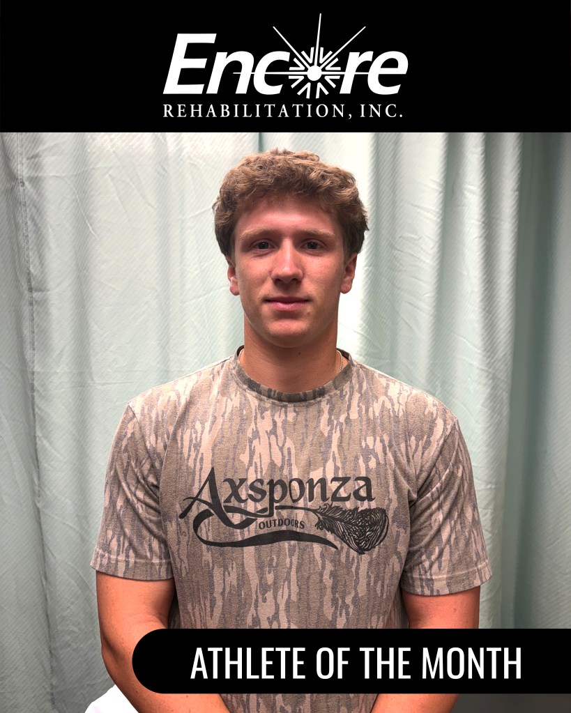 College baseball player Holton Hatzog smiling inside the Encore Rehabilitation-William Carey as he is recognized as Athlete of the Month, 