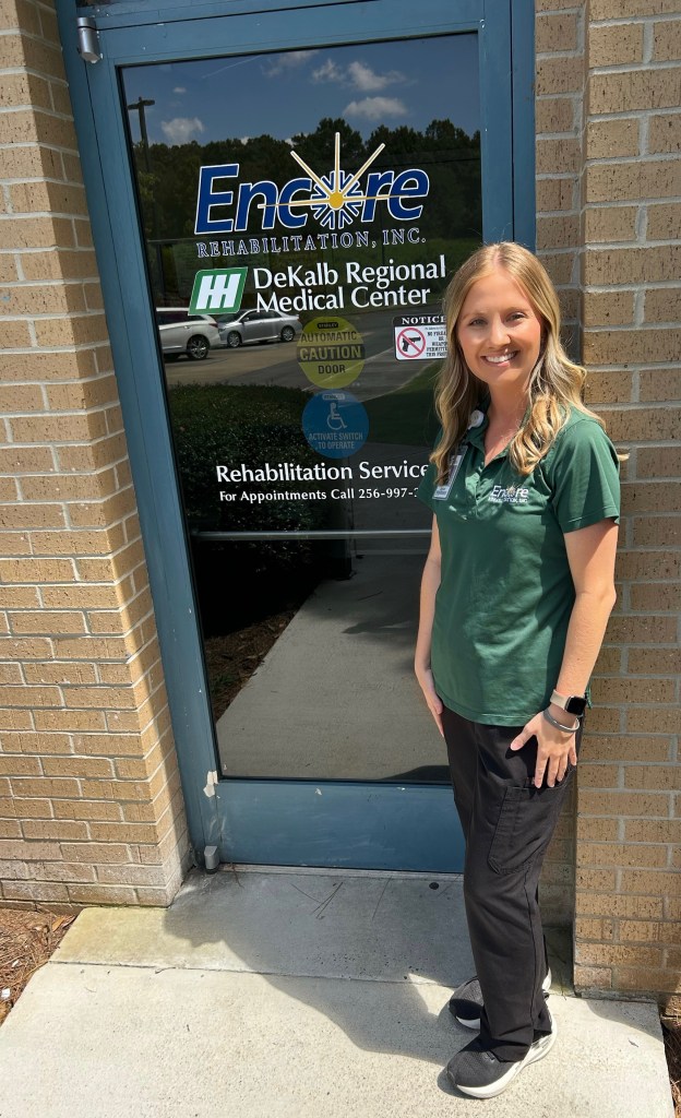 smiling adult female named Jaylah Martin, Occupational Therapist, stands outside of Encore Rehabilitation at DeKalb Regional Medical Center
